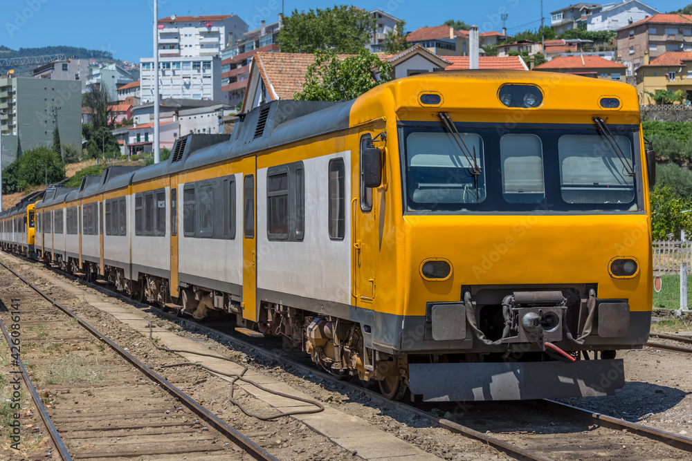 Front view of a regional train, typical of the Portuguese train network, at the train station in the city of Peso da Regua