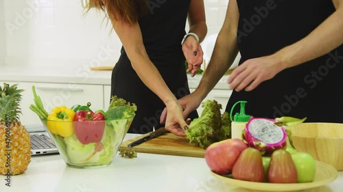 Man and woman couple in casual outfit preparing healthy food salad for self care in modern kitchen