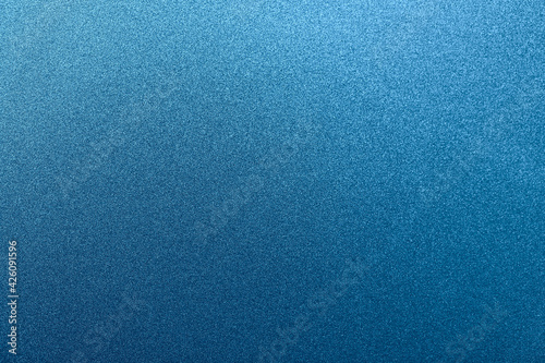 Blue grainy background. Sparkling foiled glitter. Abstract stock texture. Macro photo.