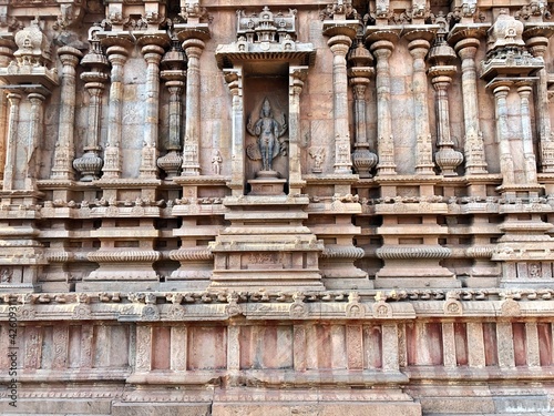 Detail of the facade of the exterior wall of Brihadeeswarar temple in Thanjavur, Tamilnadu. Indian art of bas relief carving on the stone wall of ancient Hindu temple in Tamil nadu.