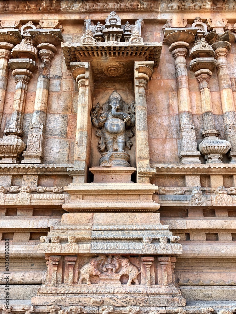 Detail of the facade of  the exterior wall of Brihadeeswarar temple in Thanjavur, Tamilnadu. Indian art of bas relief carving on the stone wall of ancient Hindu temple in Tamil nadu.