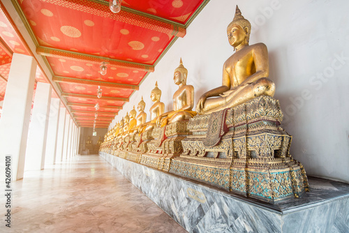 Row of magnificent Golden Buddha statue in Thailand. Art of artistic buddha. © setthawuth