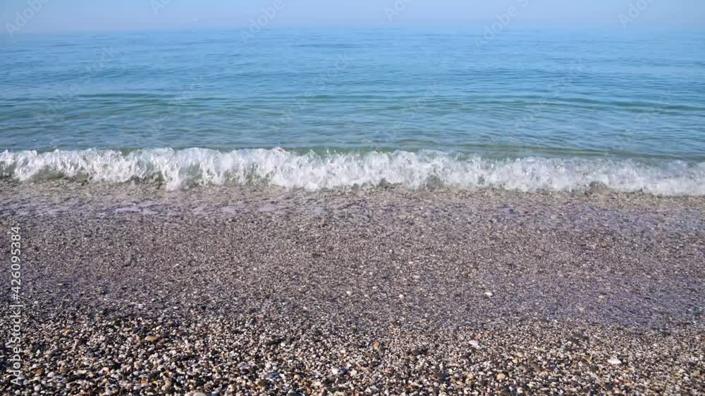 Calm morning sea. Small waves in calm conditions. Sea background Calm morning sea. Small waves in calm conditions. Sea background