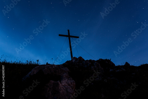 Summit cross at night, Benediktenwand mountain, Bavaria, Germany