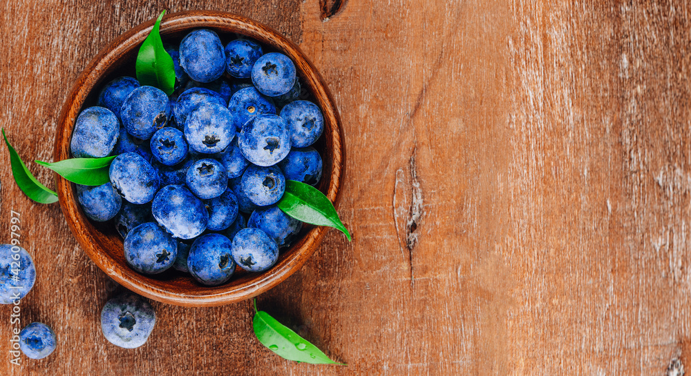 Blueberries in a bowl on a wooden background top view free space for text Blueberries in a bowl on a wooden background top view free space for text