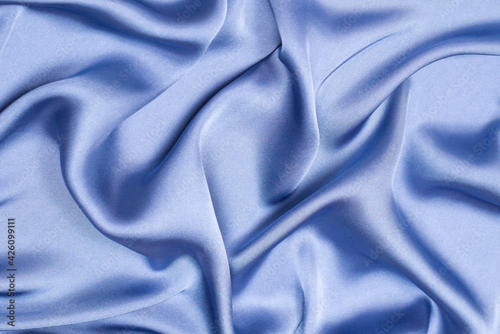 Blue silk or satin luxury fabric texture. Top view. Blue silk or satin luxury fabric texture. Top view.