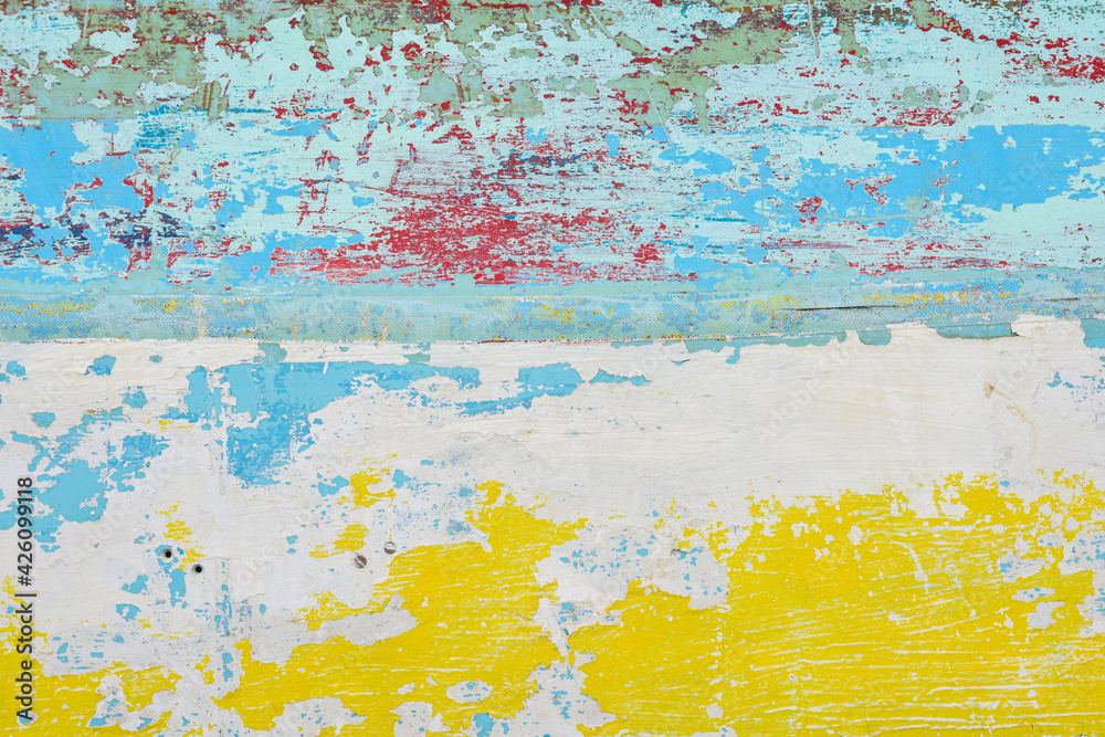 Abstract paint background with random patterns of layers of aged and weathered paint on a wood surface