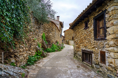Narrow alley in an old medieval town made of stone in the Sierra de Madrid. Horcajuelo.