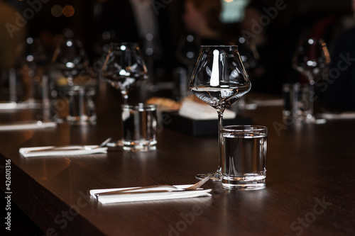 Clean glasses and cutlery on the table in the restaurant