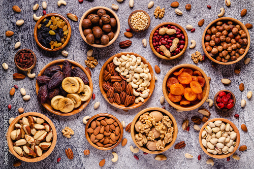Various Nuts and dried fruits in wooden bowls.