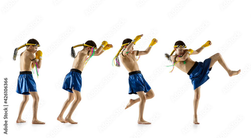 Obraz premium Little boy exercising thai boxing on white background. Fighter practicing, training in martial arts in action, motion. Evolution of movement, catching moment.