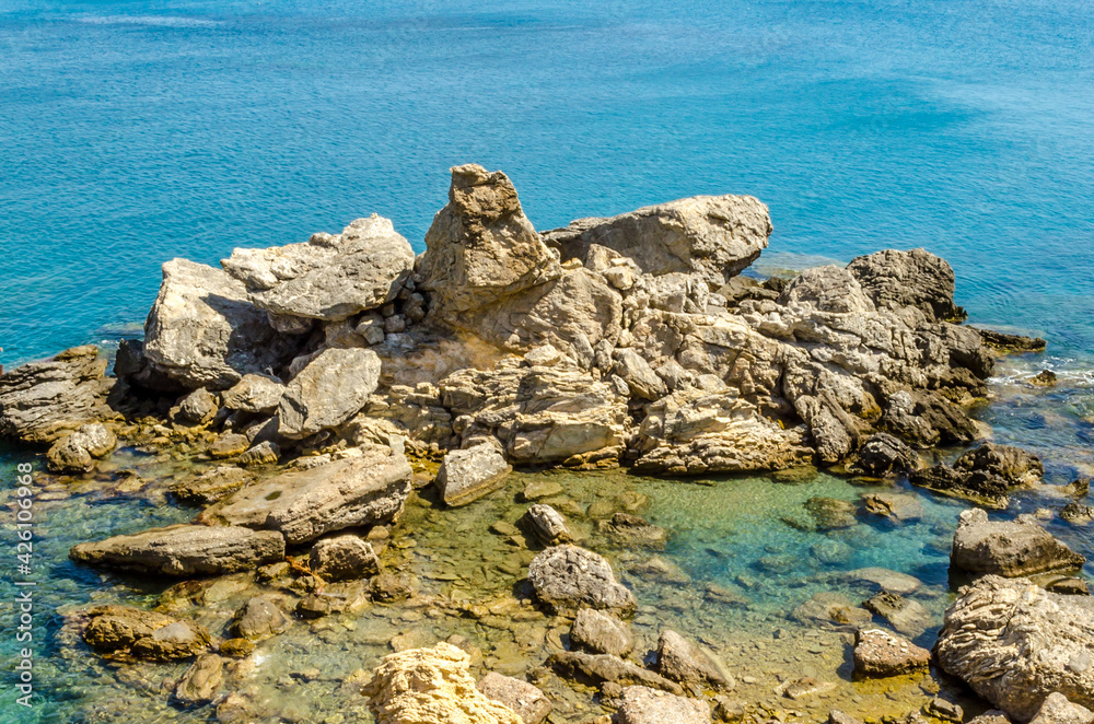 Strange Shape Rocks on the Seashore in Preveli Beach at Greek Island Crete, Greece. Beautiful Blue Water Colors Strange Shape Rocks on the Seashore in Preveli Beach at Greek Island Crete, Greece. Beautiful Blue Water Colors