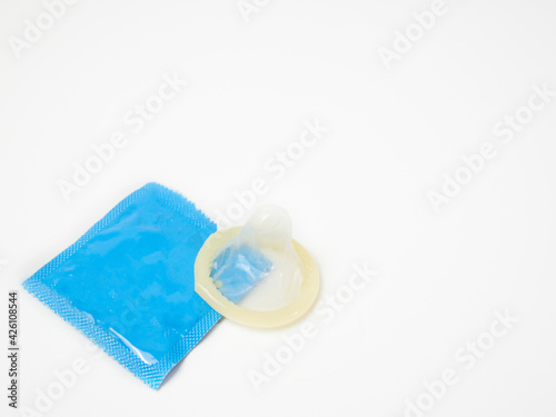 Cream color Condom with light blue package on white background. Sex protect concept.