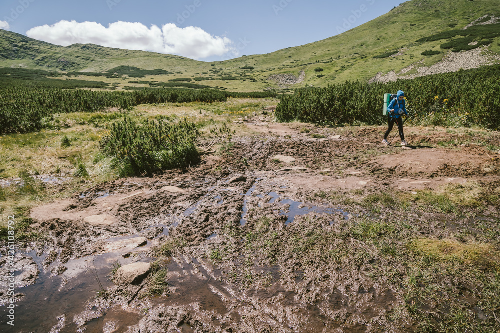 A man standing on a rocky hill