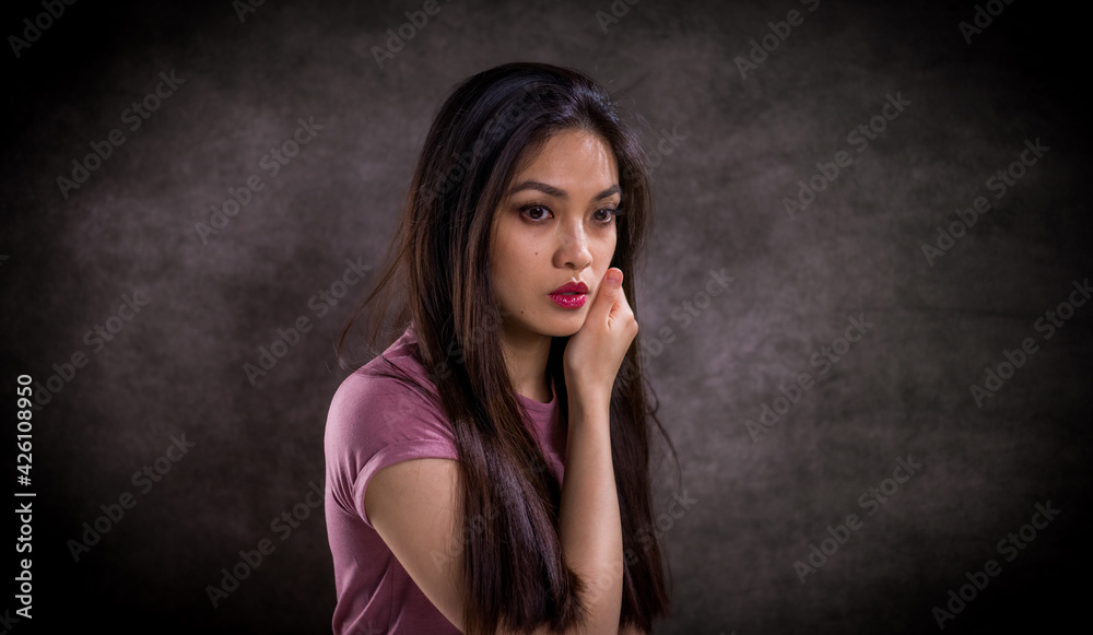 Obraz premium Pretty Asian woman - portrait shot against grey background - studio photography