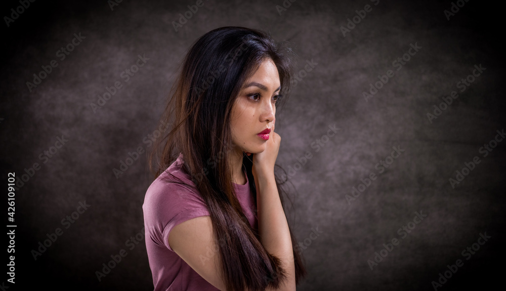 Pretty Asian woman - portrait shot against grey background - studio photography Pretty Asian woman - portrait shot against grey background - studio photography