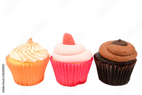 Chocolate, raspberry and lemon cupcakes arranged in a row