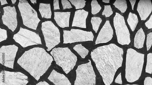 Abstract background. The texture of the masonry is black and white. Close-up of the rough texture of a large stone. Stone surface for natural background. Close-up 