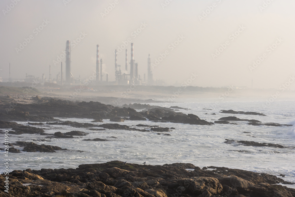 Oil refinery by the sea in the smog
