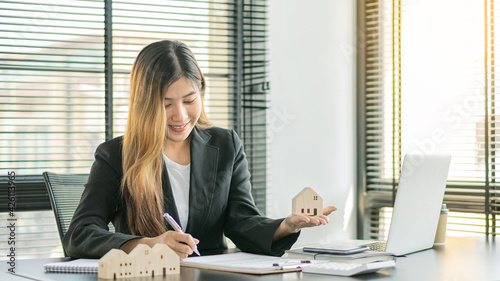 Photos Real estate brokerage ideas for sale or rent with a house on the table at the office