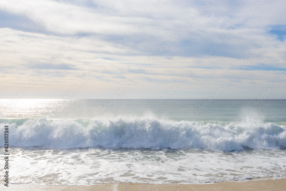 Set of pictures of a fantastic ocean wave in different stages. Cloudy sunrise sky. San Jose del Cabo. Mexico.