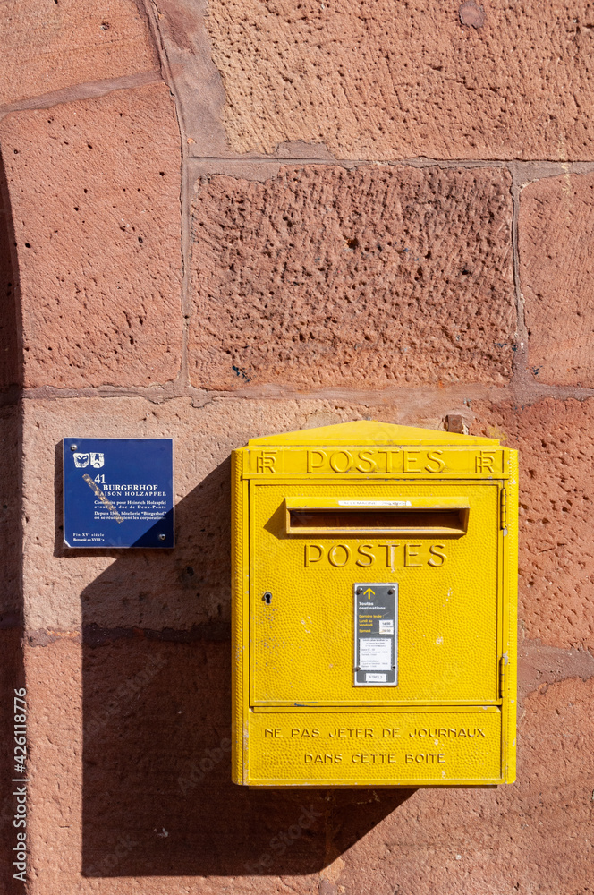 Wissembourg, France. September 13th, 2009. Yellow mailbox on the facade of a building in the historic center of the town. Wissembourg, France. September 13th, 2009. Yellow mailbox on the facade of a building in the historic center of the town.