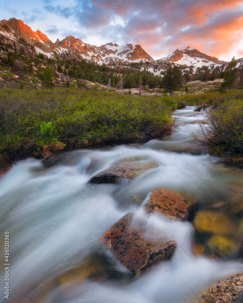 United States, Nevada, Waterfall on stream with mountain range in background United States, Nevada, Waterfall on stream with mountain range in background