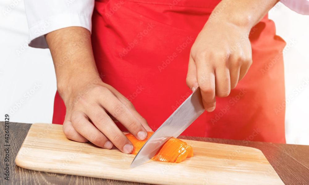 Chef hands cutting red fresh pepper Chef hands cutting red fresh pepper