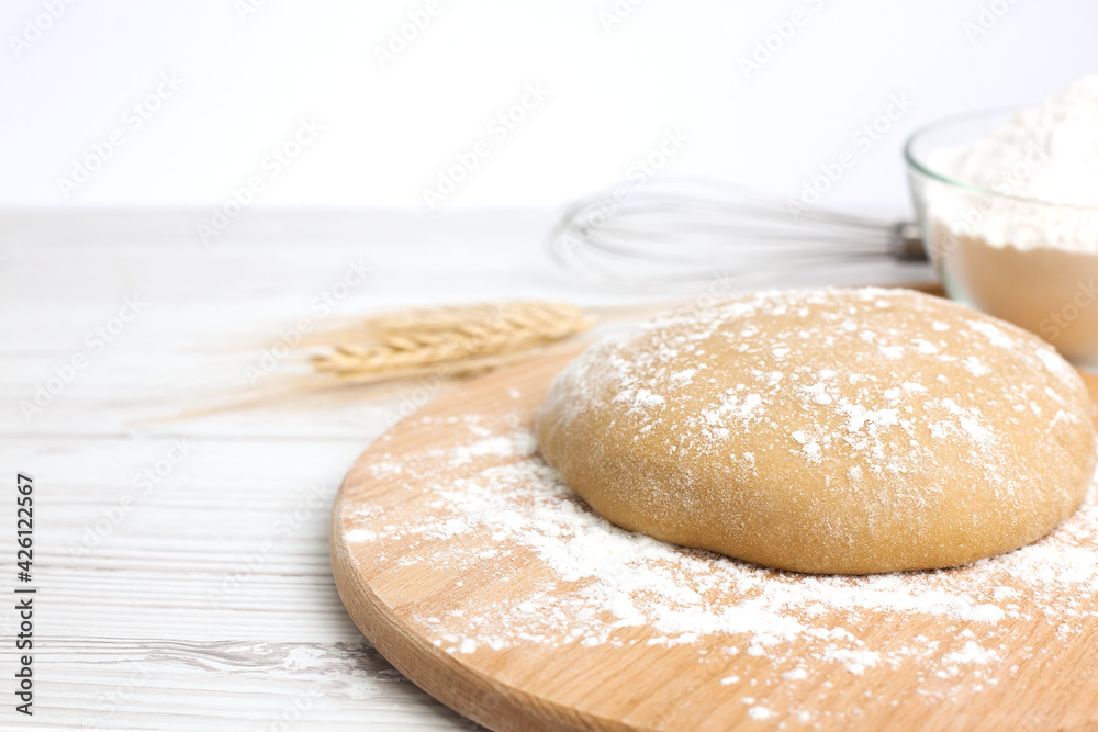 Close-up of dough on wooden board. The process of preparing and baking dough products. Copy space. Close-up of dough on wooden board. The process of preparing and baking dough products. Copy space.