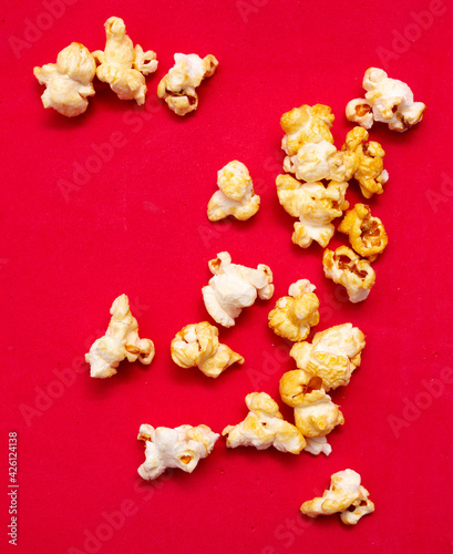Close-up of popcorn on a red background.