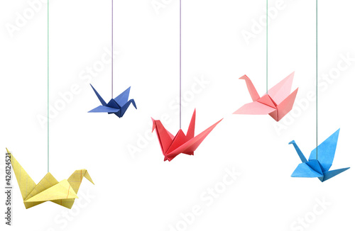 Hanging colorful origami paper birds on white