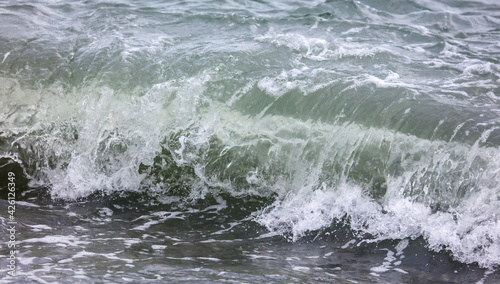 Wave in the sea with splashing water. © schankz