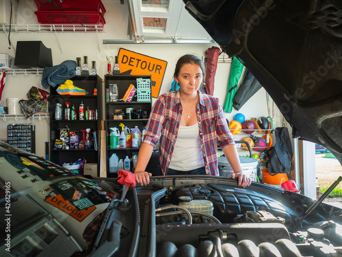 Woman fixing car in garage photo