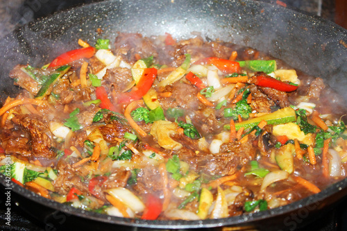 A close-up of Bulgogi, a Korean beef stir-fry, in a frying pan.