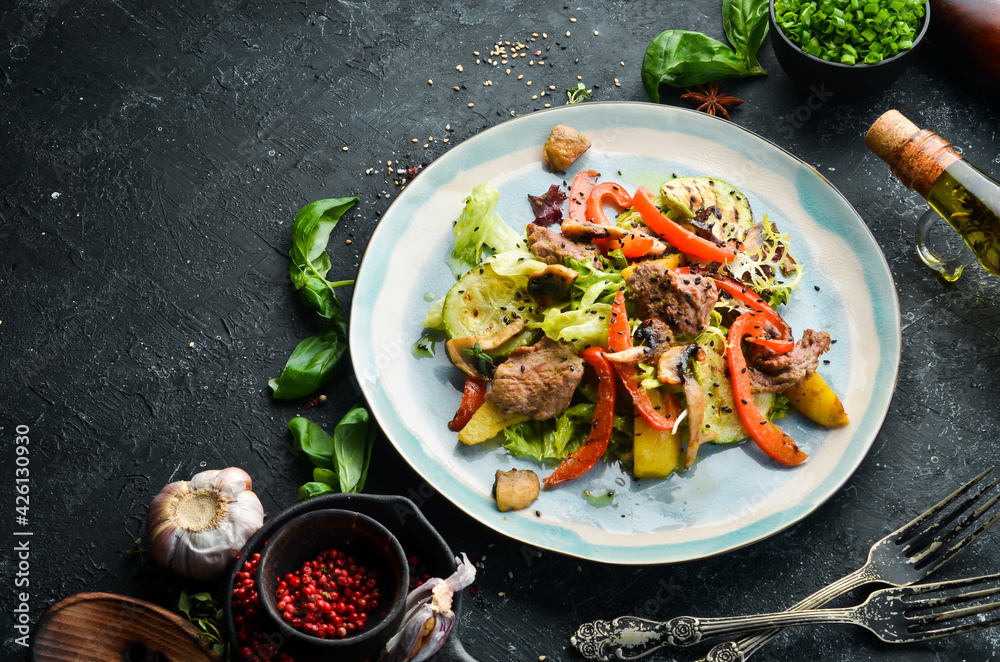 Salad with veal, mushrooms and zucchini. Top view. Rustic style.