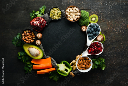 Food background: fruits, vegetables and berries on the old kitchen table. Top view. Rustic style.
