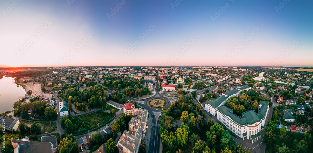 Aerial panorama view of roundabout road with circular cars in small european city at cloudy autumn day