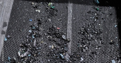 Top view of waste from used batteries on a conveyor net after magnetic separation. Processing. Environmental protection concept. photo