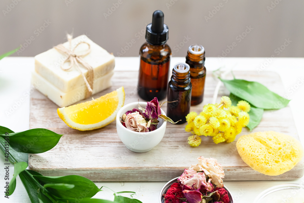 Concept of spa treatment with natural organic products. Essential oil, herbal and flower extracts, fresh plants. Atmosphere of relaxation, zen, aromatherapy. Homemade skin and body care. Close up