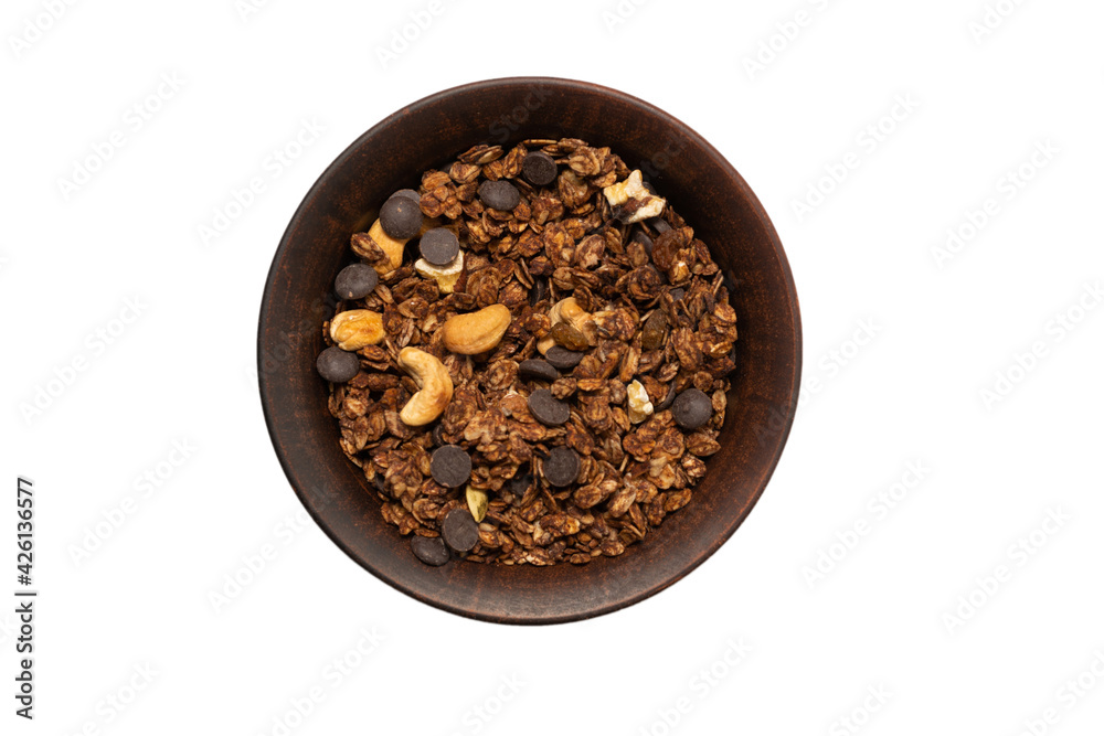 Chocolate granola cereal with nuts in a bowl background. Chocolate granola cereal with nuts in a bowl background.