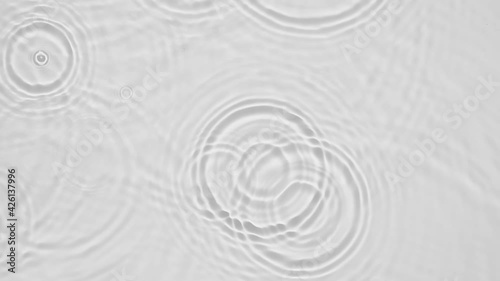 Up close, top view, Slow motion various waves of the water surface hitting the sun's rays, making them sparkle according to different patterns on a gray background video 4K.
