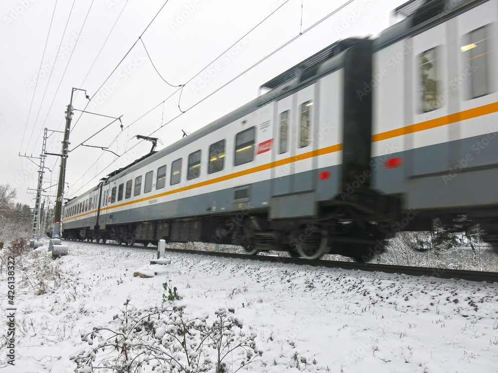 Russian train approaches suburban station in winter