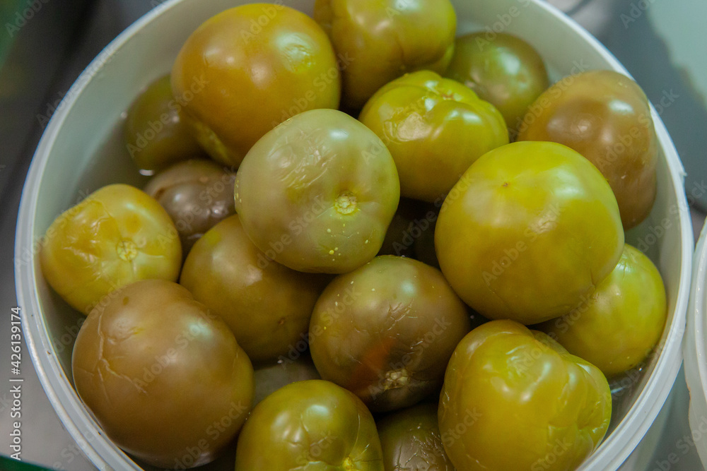 Selling salted green tomatoes at the vegetable market Selling salted green tomatoes at the vegetable market