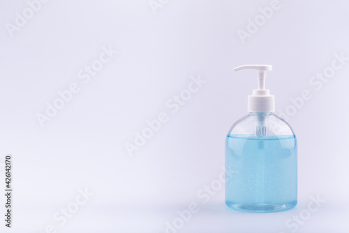 Alcohol gel for hand wash in plastic pump  bottle on white background. Light blue hand gel in half round bottle for protect Corona Virus Covid 19.