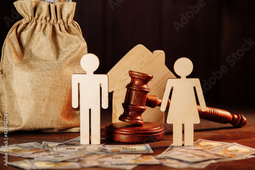 The division of property and divorce concept. Bag of money, house, people and the judge's hammer photo