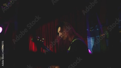 KOVROV, RUSSIA, MAY 25, 2017: Bass guitarist plays on stage. Rock concert in the club. Party at the nightclub. photo