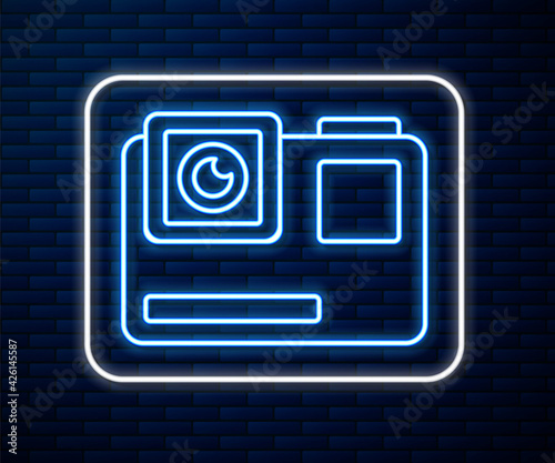 Glowing neon line Action extreme camera icon isolated on brick wall background. Video camera equipment for filming extreme sports. Vector Illustration