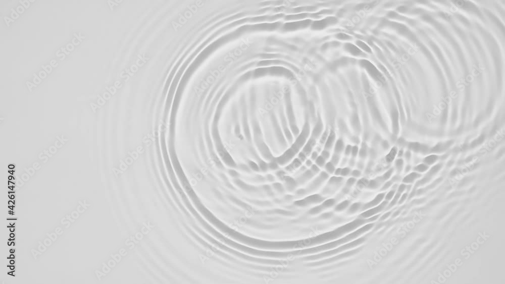 Up close, top view, Slow motion various waves of the water surface hitting the sun's rays, making them sparkle according to different patterns on a gray background video 4K. Up close, top view, Slow motion various waves of the water surface hitting the sun's rays, making them sparkle according to different patterns on a gray background video 4K.