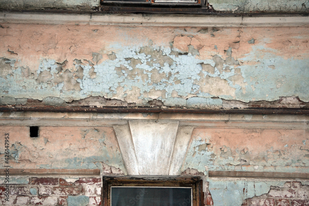 Elements of the architectural decor of the building. A fragment of the wall of an old stone house with peeling plaster. Elements of the architectural decor of the building. A fragment of the wall of an old stone house with peeling plaster.