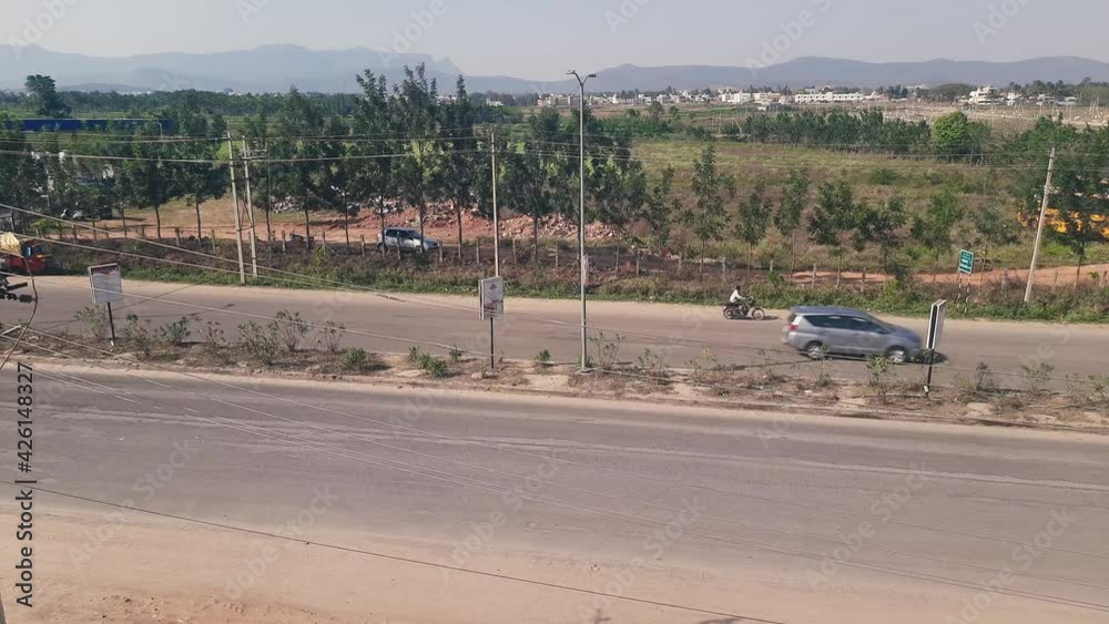 Static high angle shot of traffic on an Indian road during daytime Static high angle shot of traffic on an Indian road during daytime